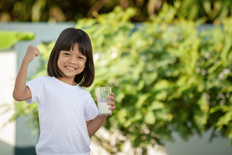 Child holding glass of milk